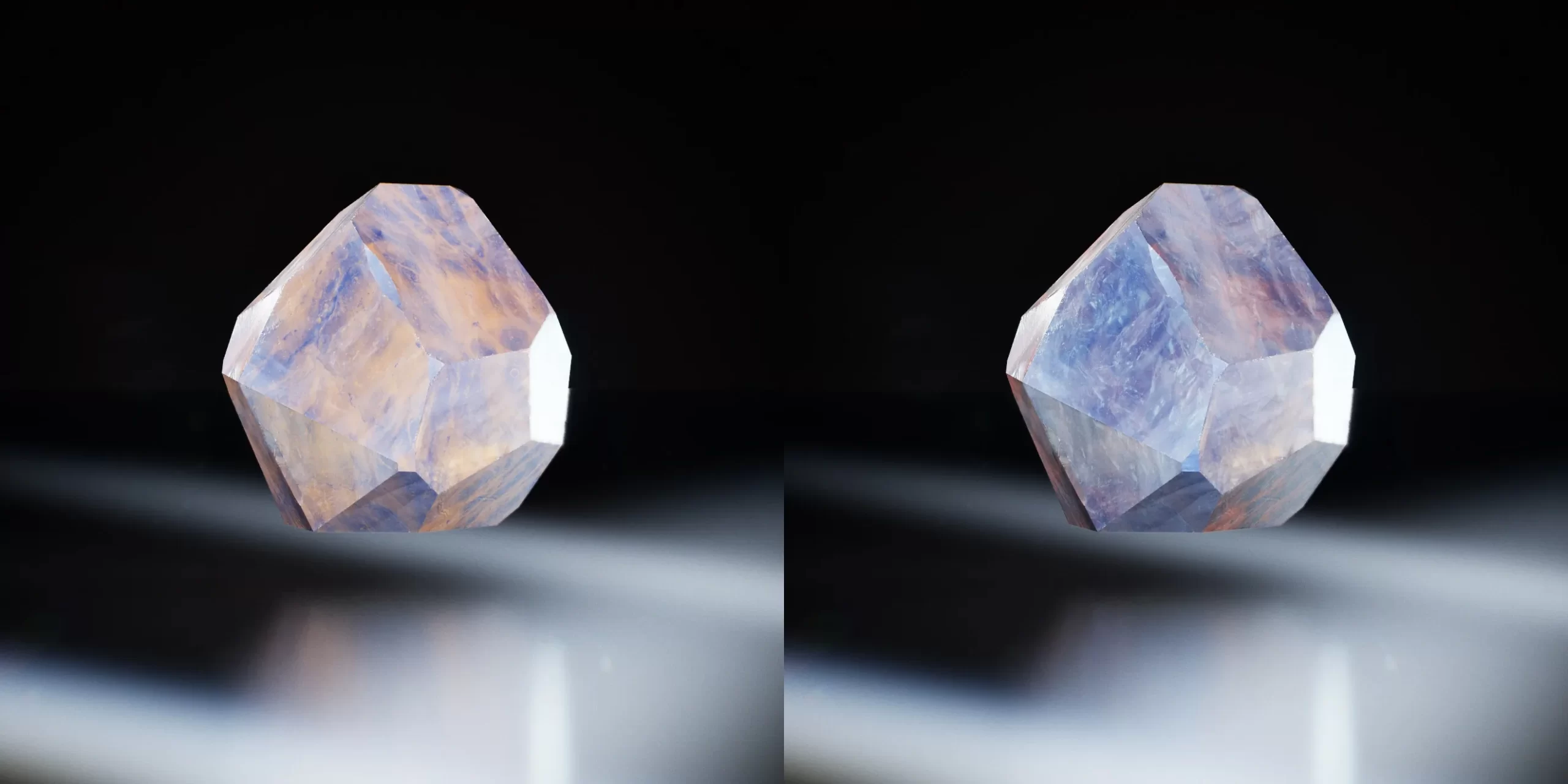 暖色调水晶渲染 黑色背景上并排两颗多面水晶,呈桃色与蓝紫交织的暖色调